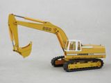 a toy excavator that is sitting on a white surface