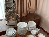 many plates and bowls on the table in the room