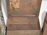an old metal box sitting on a table next to other items
