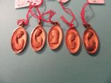 six bronze medal medals with red ribbons hang on a blue surface