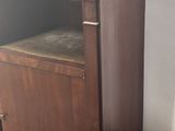 a small wooden cabinet with a marble top