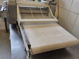 an image of a machine that is making pizza dough