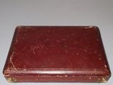 a red suitcase sitting on a white surface
