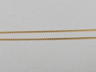 a pair of gold chains on a white background