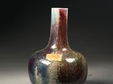 a vase that is sitting on a table with a black background