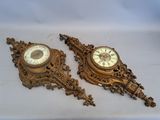 pair of antique wall clocks on a white background