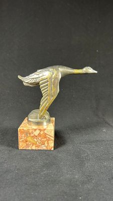 an image of a bronze bird on a marble base