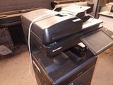 a stack of printers sitting on top of each other in a room