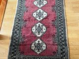 rug on the floor in a living room with a wooden floor