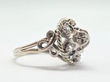 a close up of a silver ring with a flower design on it