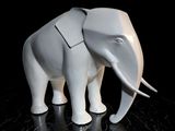 a white elephant that is standing on a black surface