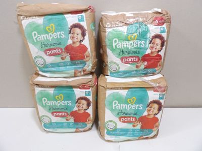 three boxes of pampers diapers sitting on top of a table
