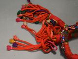 a close up of a red string with beads on it