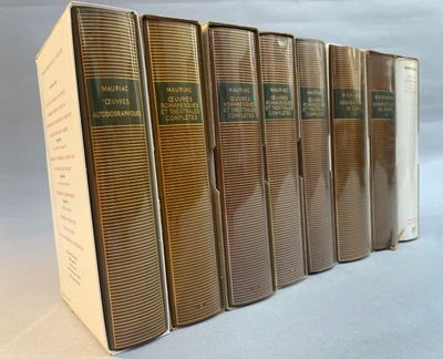 six books are lined up in a row on a white surface