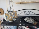 a black bench with a purse and a purse on it