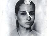 a black and white photo of a woman with a flower in her hair