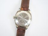 a close up of a wrist watch on a white surface