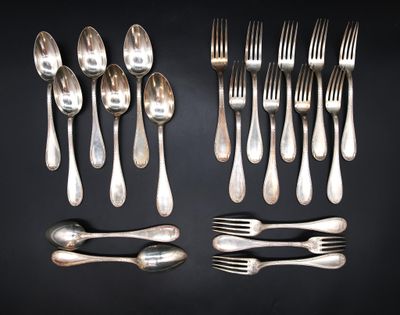 many forks and spoons laid out on the table