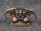 a close up of a bronze figurine of two birds on a table