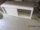 a picture of a white entertainment center in a garage