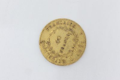 a close up of a gold coin on a white surface