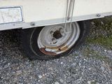 a white trailer that has a flat tire on it
