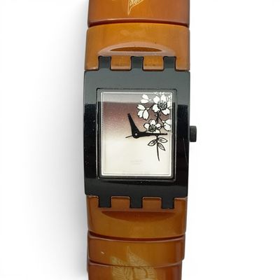 a watch that is sitting on a brown strap