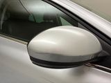 a side view mirror of a car with a reflection on the side of it