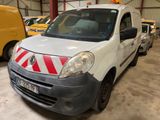 a white van with red and white stripes parked in a garage