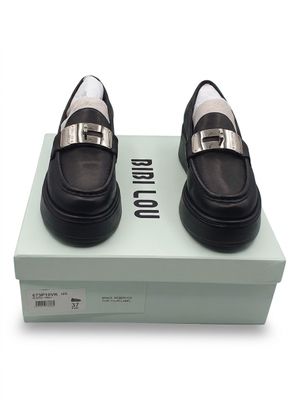 they are two pairs of black and white shoes on top of a box
