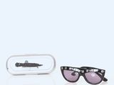 pair of black sunglasses with pink lenses in a white case