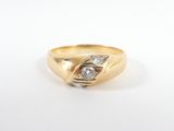 a close up of a gold and diamond ring on a white surface
