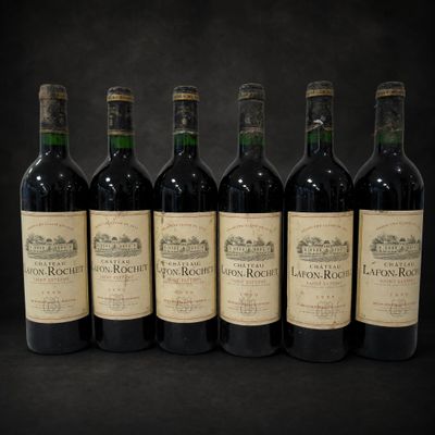six bottles of wine are lined up in a row on a black background