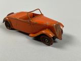 an orange toy car sitting on top of a white surface