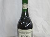 bottles of wine sit on a white surface with a white background