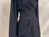 a close up of a mannequin mannequin wearing a black jacket and skirt