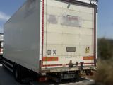 a truck that is driving down the road on the side of the road