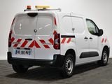 a white van with red and white stripes parked in a room