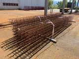 a large pile of steel bars in the middle of a parking lot