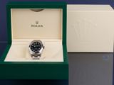a rolex watch in a box on a table