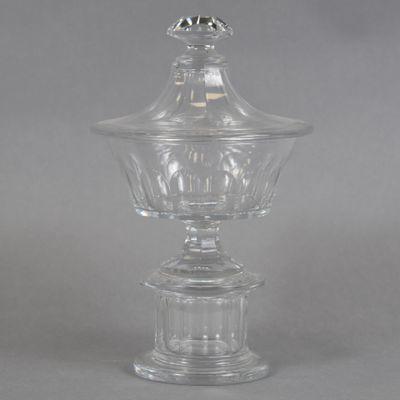 an antique clear glass bowl with a domed lid