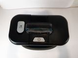 a close up of a black device on a white surface