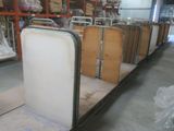 many pieces of luggage sitting on the floor in a warehouse