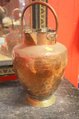 a vase sitting on a table with a mirror in the background