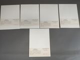 four pieces of white paper sitting on top of a table