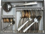 a silver tray with silver spoons and spoons in it