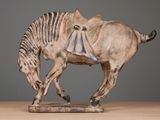 a statue of a horse with a saddle on it ' s back