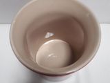 a white bowl with a red rim sitting on a table