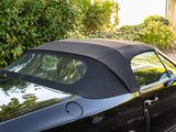an image of a black convertible car parked on the side of the road