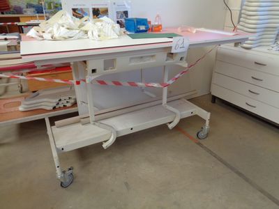 a hospital room with a hospital bed and other medical equipment